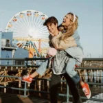 couple-pose-giant-wheel-amusement-park-travel-photography