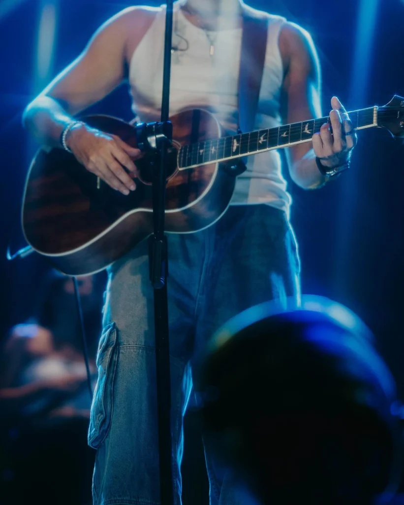 guitar, singer,blue lights,close up shot